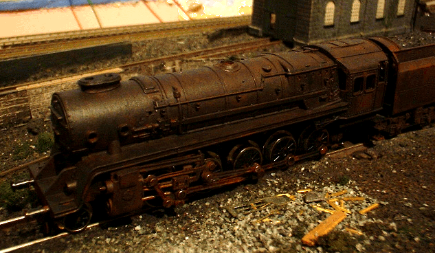 1/148th scale BR 9F heavy goods locomotive heavily weathered. Nickel-silver motion gear darkened with selenium dioxide. Oil and rust added with acrylics.